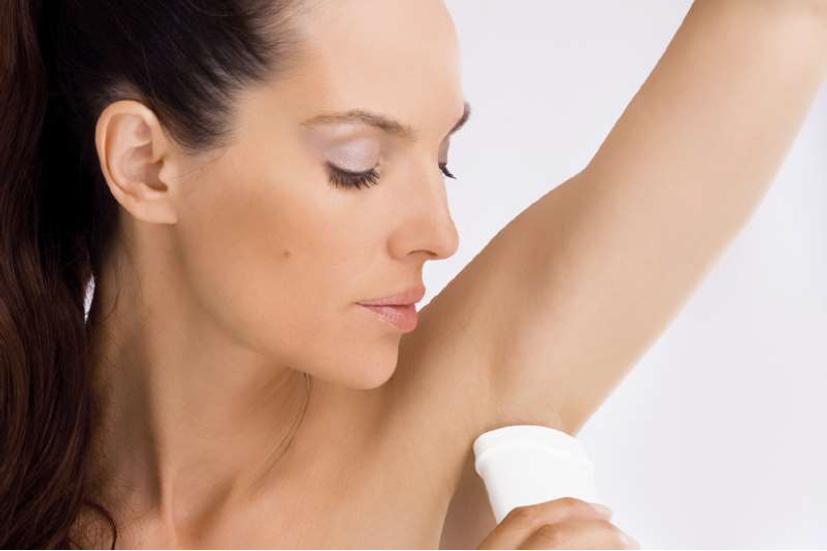 woman using deodorant