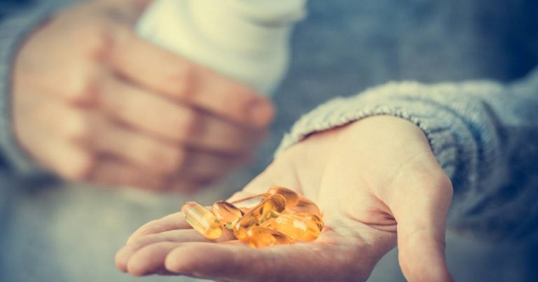 vitamins-vitamin-d-capsules-in-hand-of-man