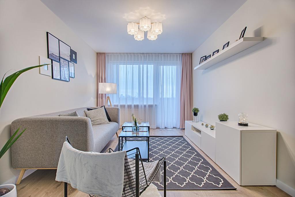 Gray Fabric Padded Sofa and Glass-top Coffee Table Inside Living Room