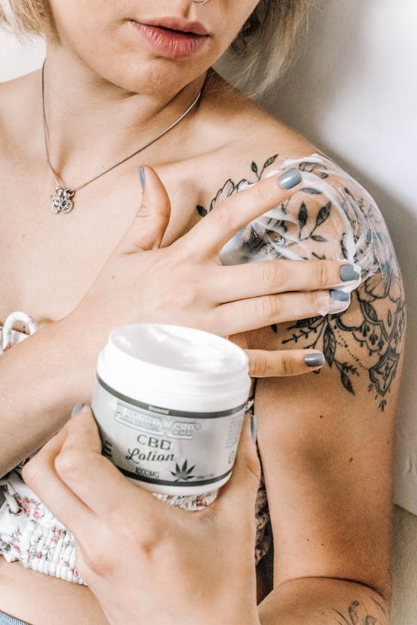 Woman Putting Lotion on Skin