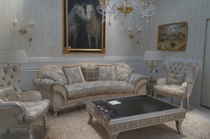 Brown Couch Under Two Horses Painting