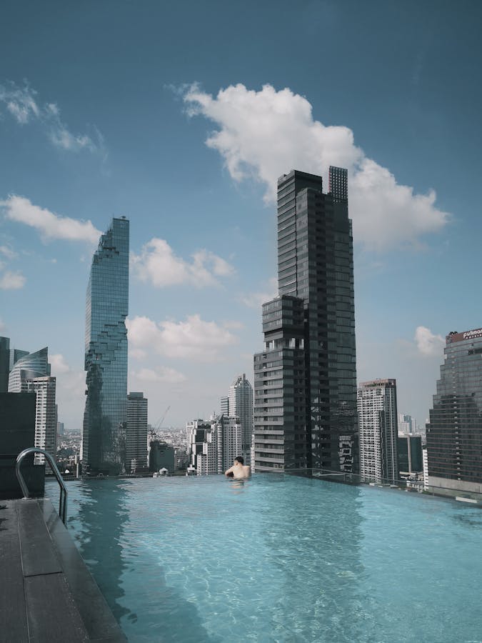 Person in Pool Looking at the Buildings