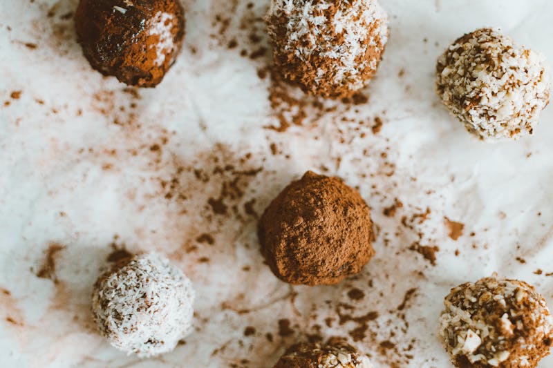 An enticing arrangement of homemade chocolate truffles dusted with cocoa and coconut flakes.