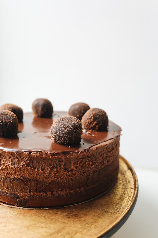 Indulge in a rich chocolate mousse cake topped with truffles, perfect for dessert lovers.