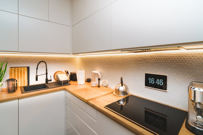 A modern kitchen featuring minimalist design with sleek countertops and advanced appliances.