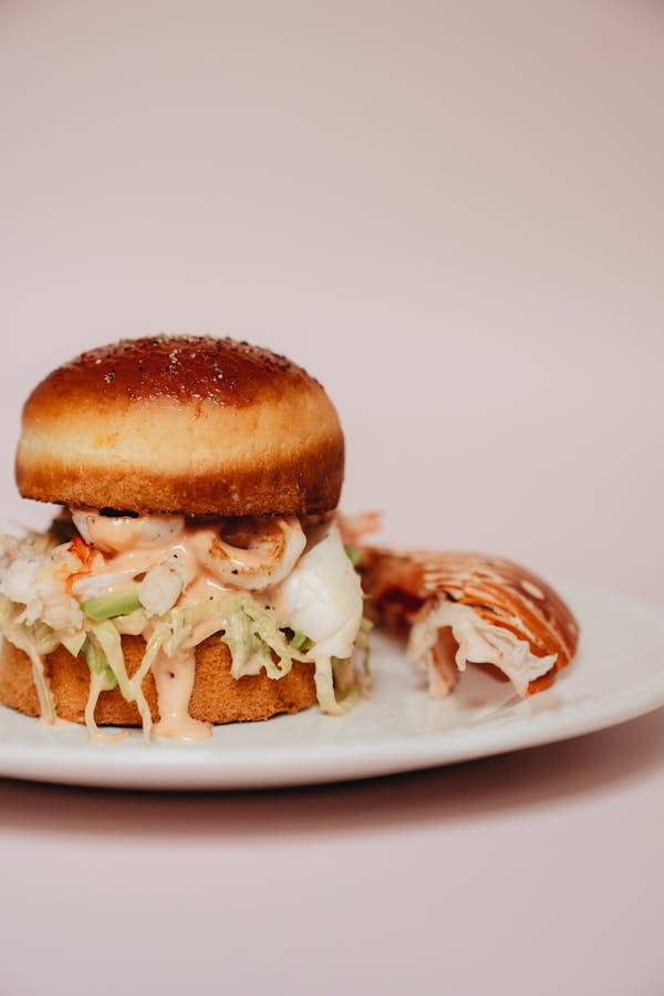 A mouth-watering lobster roll served on a plate, showcasing fresh ingredients and delicious presentation.