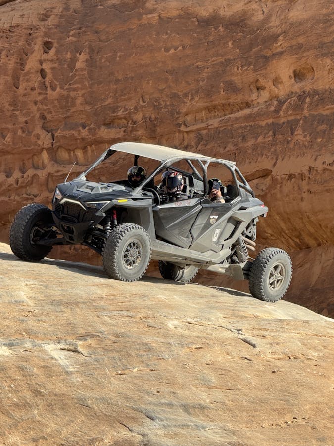 ATV navigating a rocky desert terrain, capturing thrill and adventure.